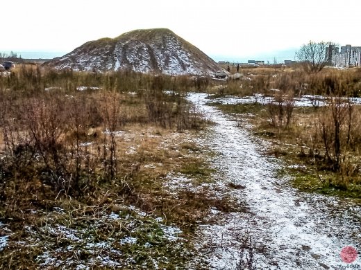 На горе из песка возле дома номер 7 по улице Набережная реки Кудьма играют дети